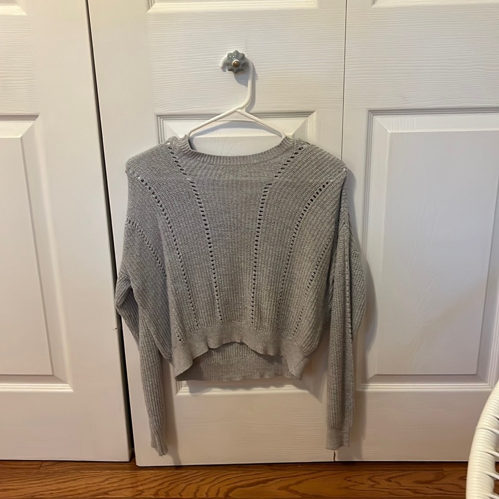 This sweater is from garage, comes in a size XS, and in grey.